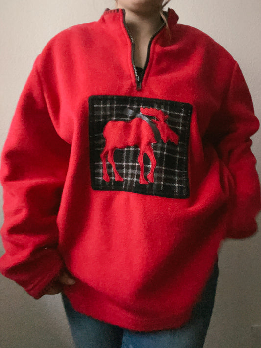 Person wearing a red sweatshirt with a horse design on a plain background Plaid Moose Fleece Pullover | From the Rack | Grace Thrifts