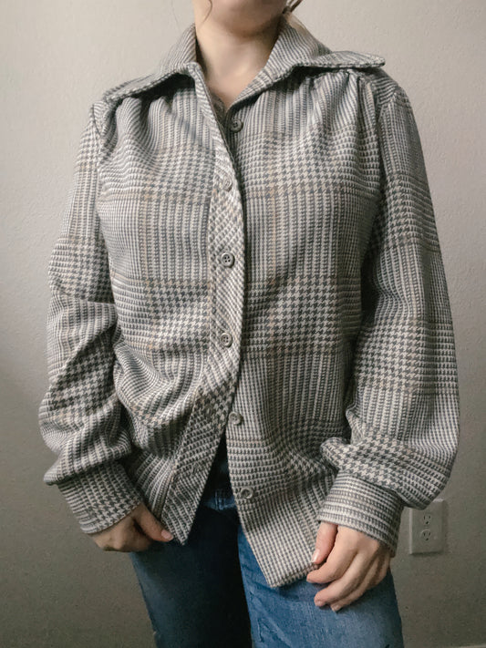 Woman wearing a checkered jacket against a plain background Grey Houndstooth Lightweight Jacket | From the Rack | Grace Thrifts