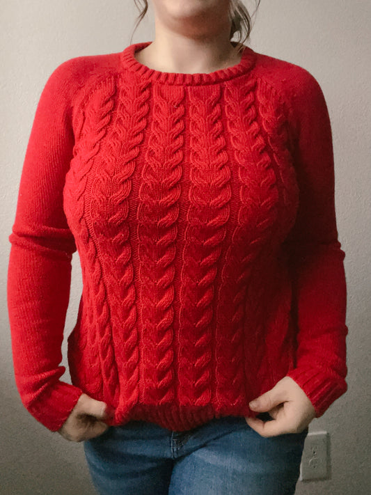 Person wearing a red cable knit sweater against a plain background Red Classic Cable Knit Sweater | From the Rack | Grace Thrifts