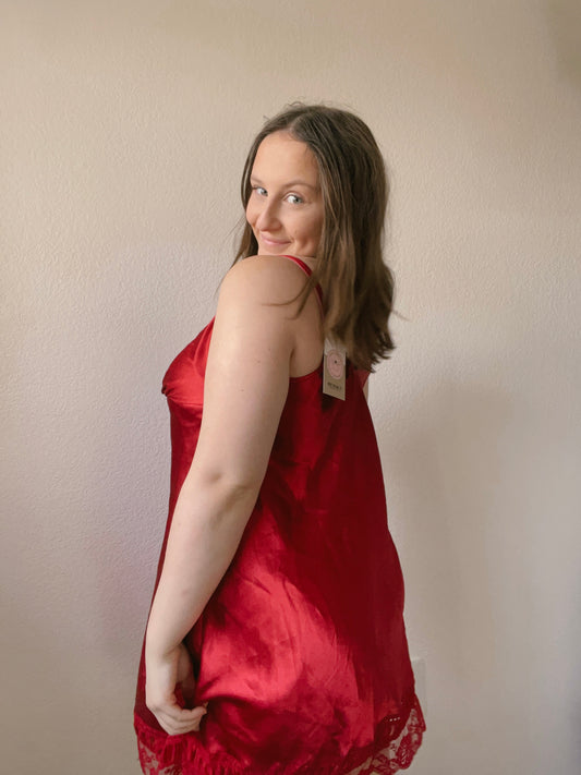 Woman wearing a red dress with a beige background