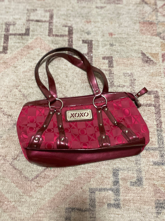Red handbag with 'XOXO' logo on a textured surface Hot Pink XOXO Purse | From the Rack | Grace Thrifts
