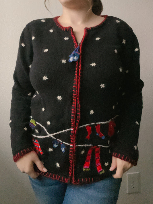 Black sweater with red trim and white star patterns worn by a person against a plain background Vintage Knit Winter Gear Sweater | From the Rack | Grace Thrifts
