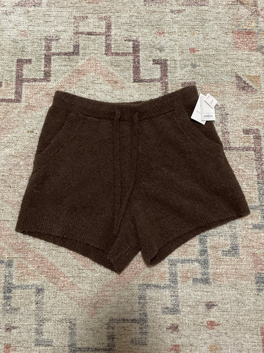 Brown shorts with a tag on a patterned rug NWT Brown Fuzzy Lounge Shorts | From the Rack | Grace Thrifts
