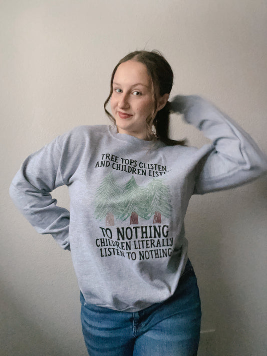 Gray sweatshirt with nature-themed text and graphics worn by a person. NWT Children Listen To Nothing Crewneck | Grace Thrifts