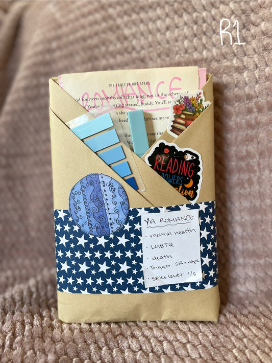 Decorative envelope with star pattern, stickers, and paper items on a textured surface