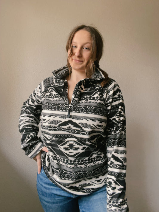 Person wearing a black and white patterned pullover against a plain background B&W Eddie Bauer Pullover | From the Rack | Grace Thrifts