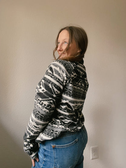 Person wearing a black and white patterned pullover against a plain background B&W Eddie Bauer Pullover | From the Rack | Grace Thrifts