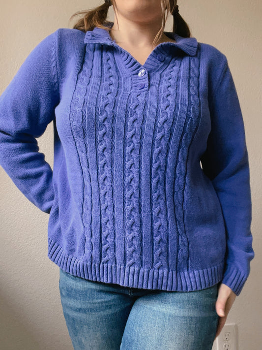 Woman wearing a blue cable knit sweater against a plain background Indigo Cable Knit Pullover | From the Rack | Grace Thrifts