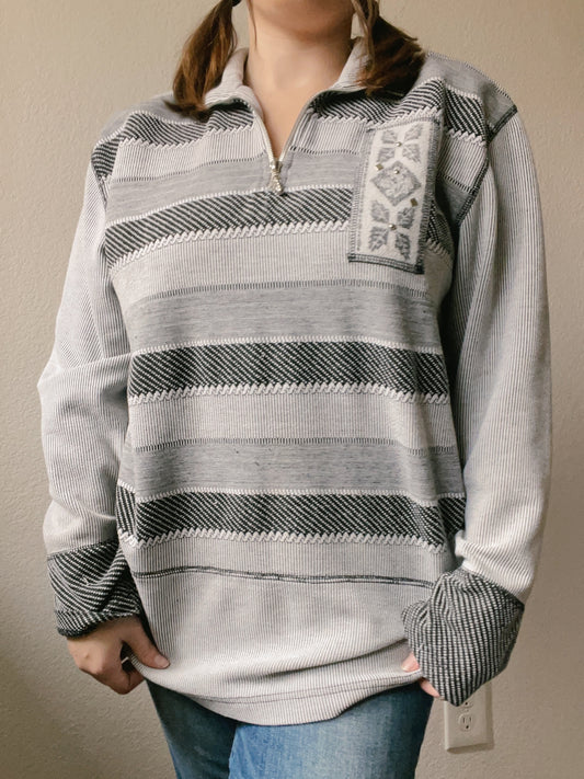 Woman wearing a patterned sweater with a plain background Grey Striped Snowflake Pullover | From the Rack | Grace Thrifts